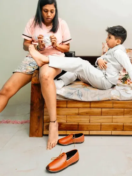 A candid moment of a sister helping her little brother with his socks. These quiet, behind-the-scenes family moments are priceless.