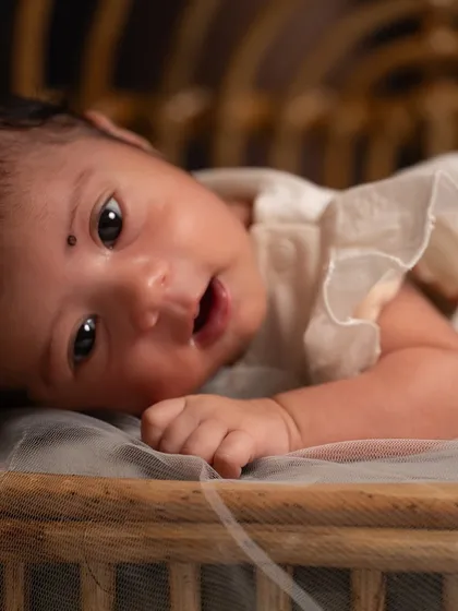 An awake and curious newborn making eye contact with the camera. I always take time to capture these moments of alertness, showing the baby's budding personality.