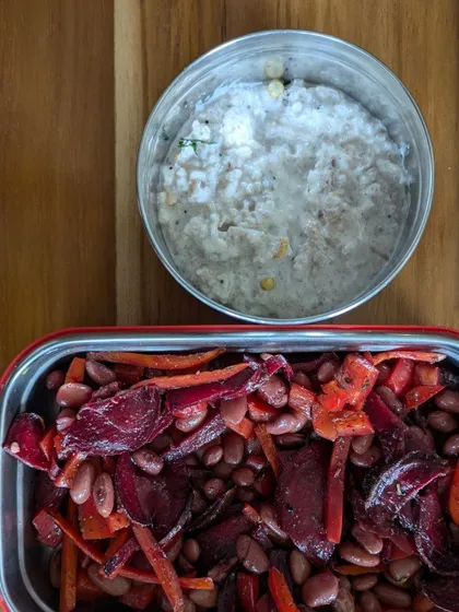 A balanced lunchbox featuring a rajma, beetroot, and carrot salad with a side of peanut curd rice. I focus on holistic meals, not just counting calories.