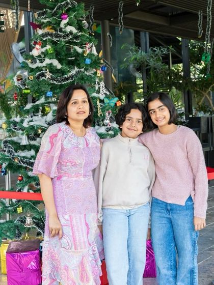 A mother and her two children in front of our Christmas tree. The festive season is always a magical time for the little ones here.