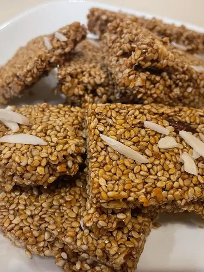 This homemade Gud Gajak is a nourishing winter treat. Made with roasted sesame seeds, jaggery, and desi ghee, it's rich in calcium and fiber. When you make it at home, you can control the amount of jaggery to keep it healthier.