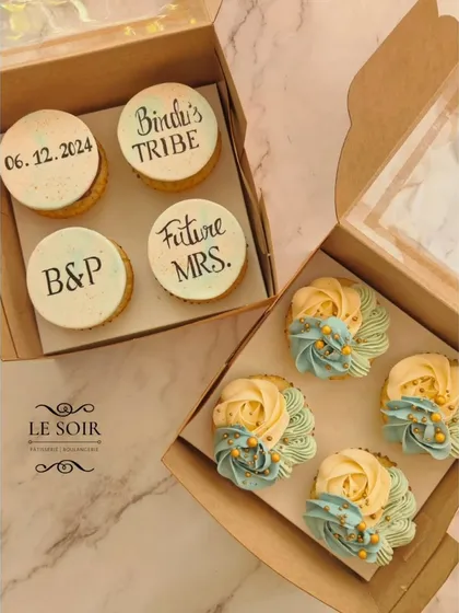 The perfect set for a bride-to-be. This order included two styles: one box with custom fondant toppers for "Bindu's Tribe" and another with elegant two-tone buttercream rosettes. It's a great way to match your theme across all your desserts.