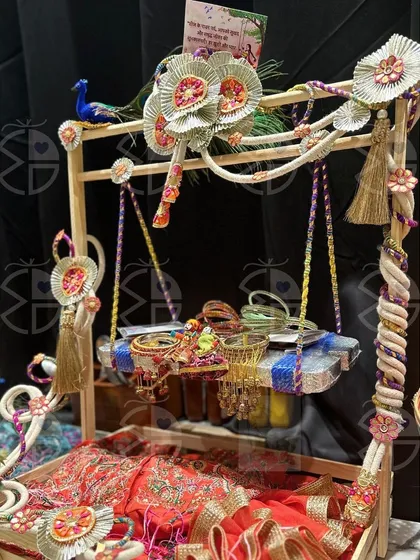 Another one of my Teej hamper designs. This one features a beautiful red 'saree' and bangles, arranged in a rustic wooden tray decorated with handcrafted flowers.