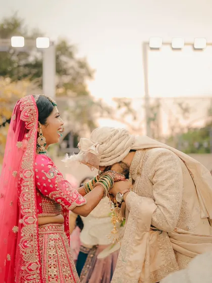 A gesture of love and respect. This candid shot captures the groom kissing the bride's hand, a sweet and chivalrous moment during their ceremony.