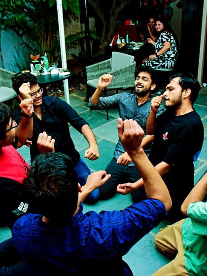 The boys having a blast, sitting on the floor and dancing together. It's all about those spontaneous, fun moments.