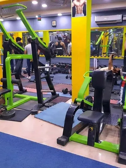 Our machine area is equipped for targeting every muscle group. This photo shows our chest press and lat pulldown machines, which are great for building upper body strength safely and effectively.