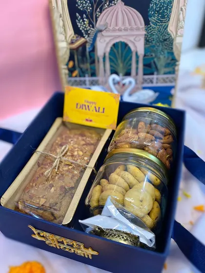 'The Joy Box' for Diwali, containing a wholewheat jaggery tea cake, almond jar, chilli cheese cookie jar, and a complimentary diya.