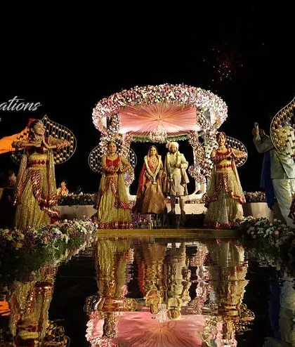 A beautiful photo of the Jaimala ceremony at St. Regis Goa, with the stage and performers reflected in the water below. This adds an extra layer of beauty and elegance to the moment.