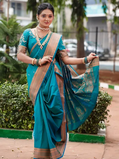 A full view of the bride, showing how the entire look is balanced and harmonious. The saree draping is clean and professional.