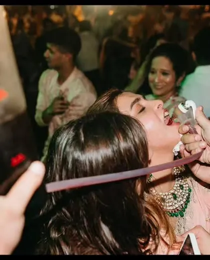 A guest enjoys a drink from our shot dispenser on the dance floor. We bring the party to you, ensuring no one misses out on the fun.