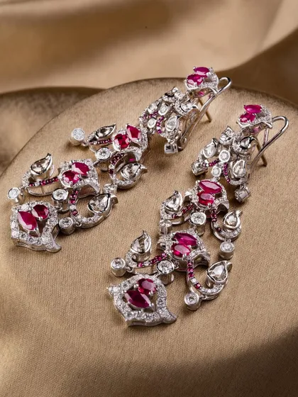 The Scarlet Royale earrings, designed to offer presence without heaviness, featuring intricate ruby and diamond work.