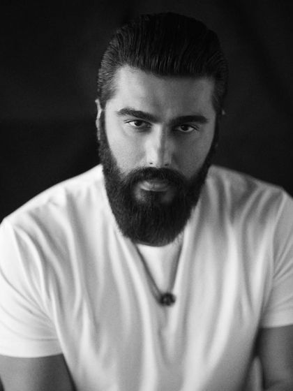 A powerful black and white portrait of Arjun Kapoor. Sometimes the most impactful styling is the simplest: a classic white tee that lets the personality shine through.