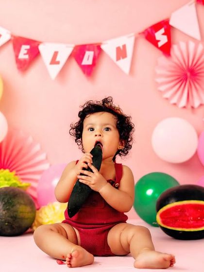 Getting a taste of the theme. Using real fruit as props adds a wonderful sensory element to the photoshoot experience for the baby.