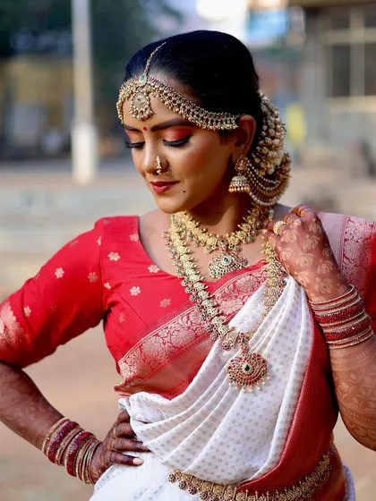 A classic bridal portrait showcasing the grace of a bride in her traditional attire. My goal is to capture the details, from the intricate jewelry to the delicate henna, creating an elegant and timeless image.