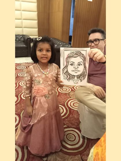 A proud little girl showing off her caricature. I make sure to capture the charm of my youngest subjects, complete with their pretty dresses and hair accessories.