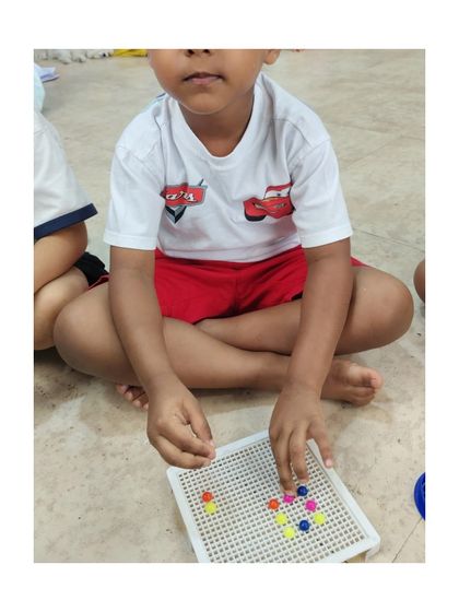 Creating patterns with colorful pegs is a fun way to introduce early math concepts and develop fine motor skills.