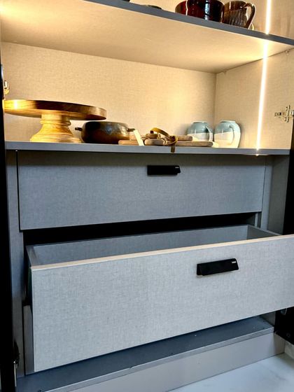 A close-up on the smooth-gliding drawers, built with German hardware for reliability. The textured laminate finish on the drawer fronts adds a subtle touch of sophistication to the overall design.