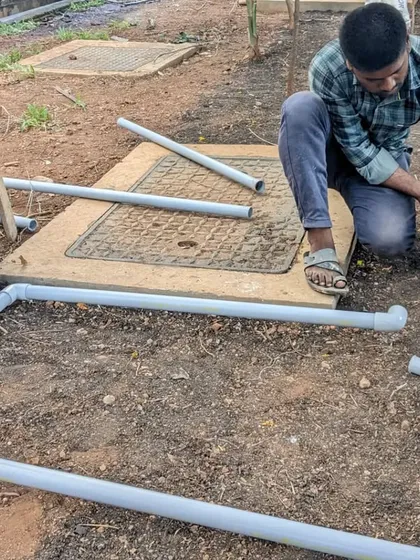 Applying solvent cement to a PVC pipe fitting to ensure a watertight seal.