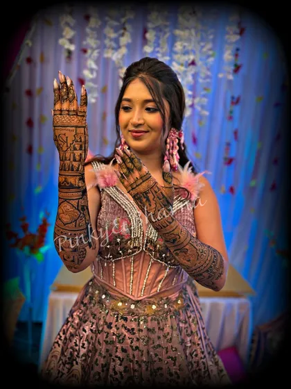 This bride looks absolutely radiant in her pink outfit, perfectly complemented by her full arm mehndi. The design is a mix of modern and traditional elements.