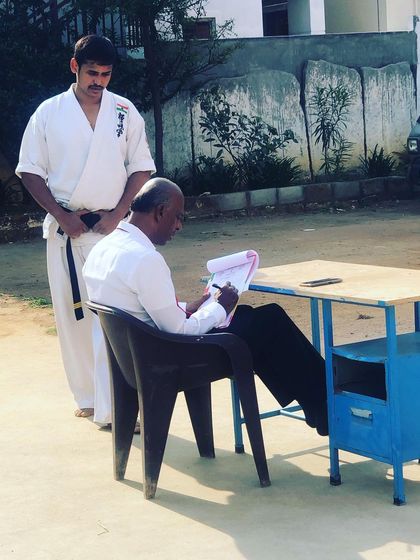 Respect for the Sensei is the first lesson in karate. Here, I am overseeing a belt grading exam, a formal process we take very seriously.