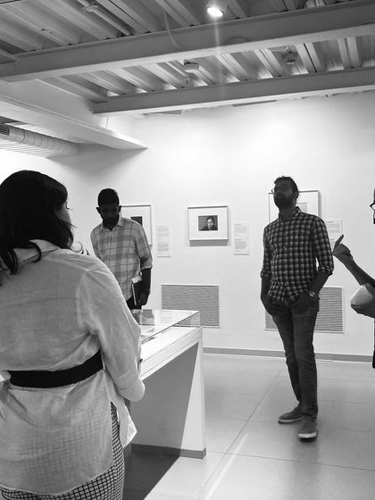An intimate moment during a guided tour of the Museum of Art and Photography (MAP). The design of the galleries allows for both large group experiences and smaller, more focused conversations.