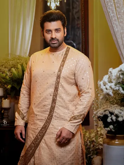 A portrait of actor Ankush Hazra in a sophisticated beige kurta. This shot showcases elegant ethnic menswear, with soft lighting that complements the subtle texture of the fabric.