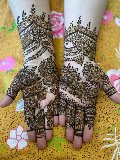 A lovely, dense design with a mix of floral and geometric elements. The patterns flow beautifully from the wrist to the fingertips, creating a very elegant look.