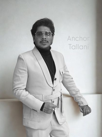 A black and white portrait. This look is all about confidence and style. As an anchor, your presence on stage is just as important as your performance.