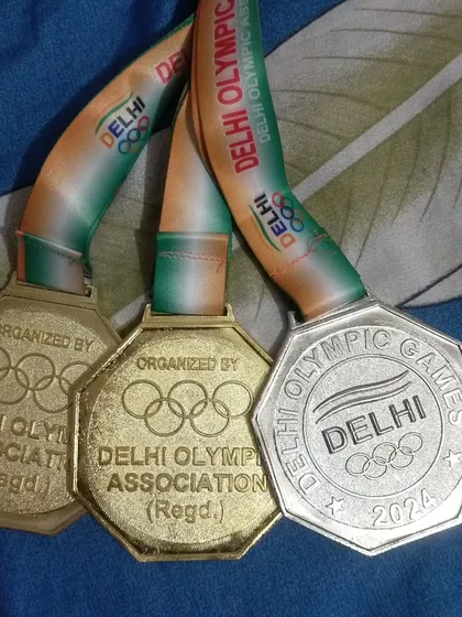 A close-up of the prestigious medals from the Delhi Olympic Games 2024. This is what we train for.