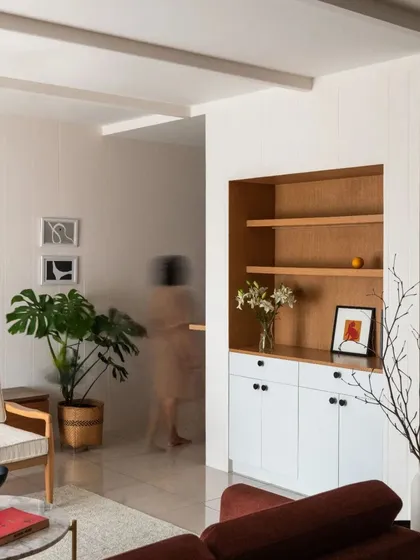 This view of the living room shows the calm and uncluttered aesthetic, with carefully selected furniture and plants adding life to the minimalist design.