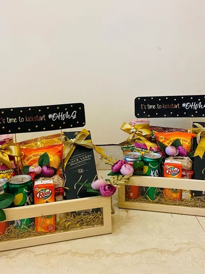 Welcome hampers for wedding guests, designed to kickstart the #DhruvGia celebrations. These wooden crates are filled with snacks, drinks, and a mini Black Label.