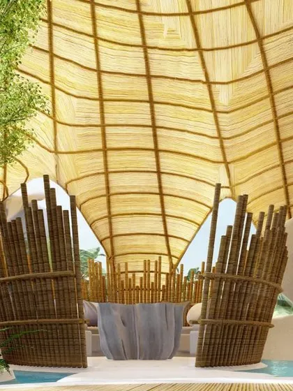 An informal outdoor seating area on an office terrace, designed to feel like a floating sanctuary. The use of bamboo, flowing water channels, and lush plants creates a tranquil and tropical oasis in the city.