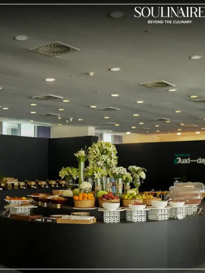 A circular buffet island featuring fresh fruits and flowers at the Buddh International Circuit. Our setups are designed to be functional and aesthetically pleasing.