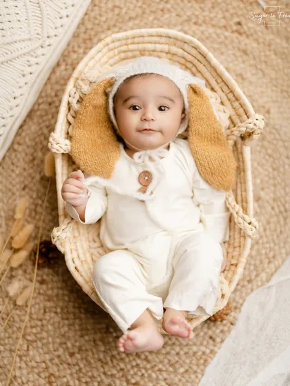 This little one is all ears in a cute bunny outfit. Sitter sessions, usually around 6-9 months, are perfect for capturing babies once they can sit up on their own.