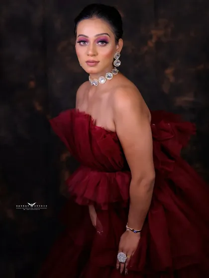 A three-quarter portrait against a classic mottled backdrop, giving the image a timeless, painterly quality.