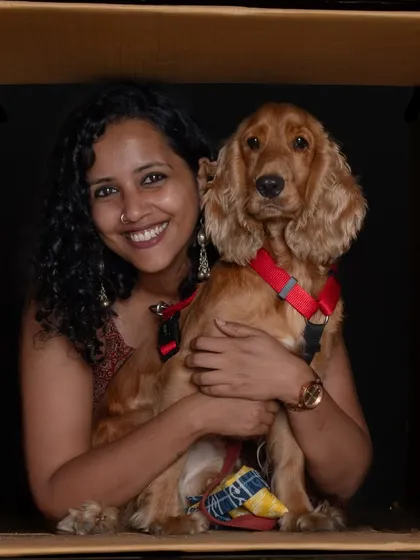 A beautiful "in the box" portrait of a woman and her cocker spaniel, radiating warmth and happiness.