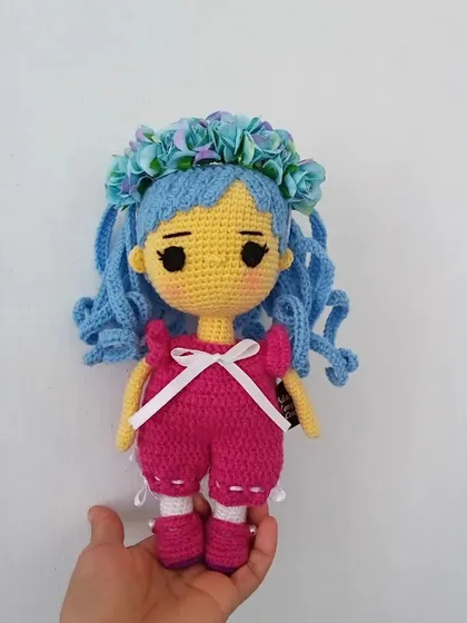 An original anime-style doll with bright blue hair and a pink outfit. I enjoy creating these colorful characters.