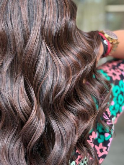 Glossy waves and mocha dreams. This luxurious hair speaks for itself with its rich color and perfect styling.