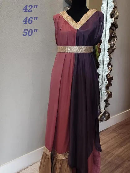 This dual-toned fusion dress creates a beautiful, flowing silhouette. The design combines two complementary colors with a gold-embroidered belt and neckline, offering a goddess-like drape that is perfect for parties and special occasions.