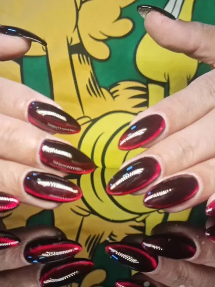 A full view of the striking red and black cat-eye manicure, perfect for a bold statement.