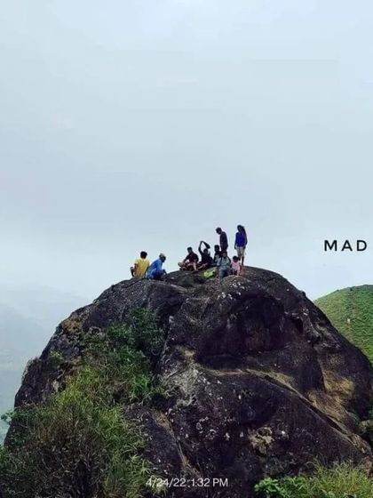 Our group resting on a large rock at the summit of Ranipuram, enjoying the panoramic views.