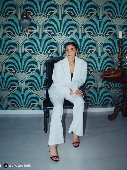 The client, Dhvani Bhanushali, in her newly designed living area. The space was created to be a safe haven away from the limelight, reflecting her personality with a blend of understated luxury, artistic flair, and serene colors.