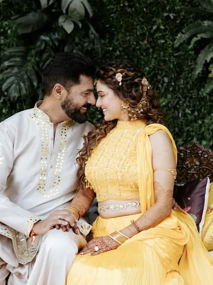 The couple sharing a quiet moment on a decorated swing, a classic and romantic element we love to include in our decor.