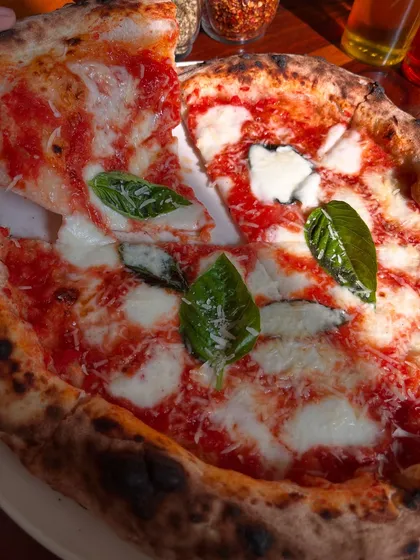 The perfect cheese pull on our classic Margherita. It's a moment of pure joy for any pizza lover.