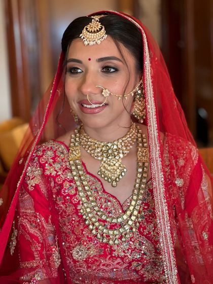 A direct portrait showing the symmetry and balance of the makeup. The bindi is the perfect finishing touch.