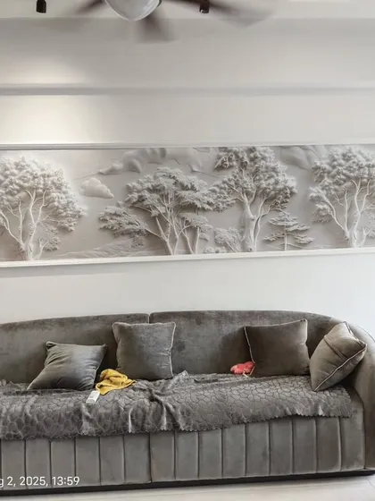 For this living room in Mulund, I installed a white 3D landscape panel. This type of textured wallpaper creates an artistic, sculptural effect that changes with the light, adding a sophisticated touch above the sofa.