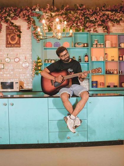 A wide shot of the musical serenade in the kitchen set.