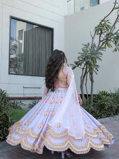 The client twirls, showing off her dramatic hairstyle and colorful outfit.