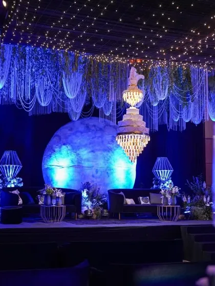 A side view of the moonlit stage, with a tall candelabra in the foreground, emphasizing the layers of light and decor.