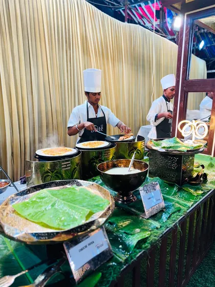 The dosa station in full swing, with chefs cooking multiple dosas simultaneously to serve guests quickly and efficiently.